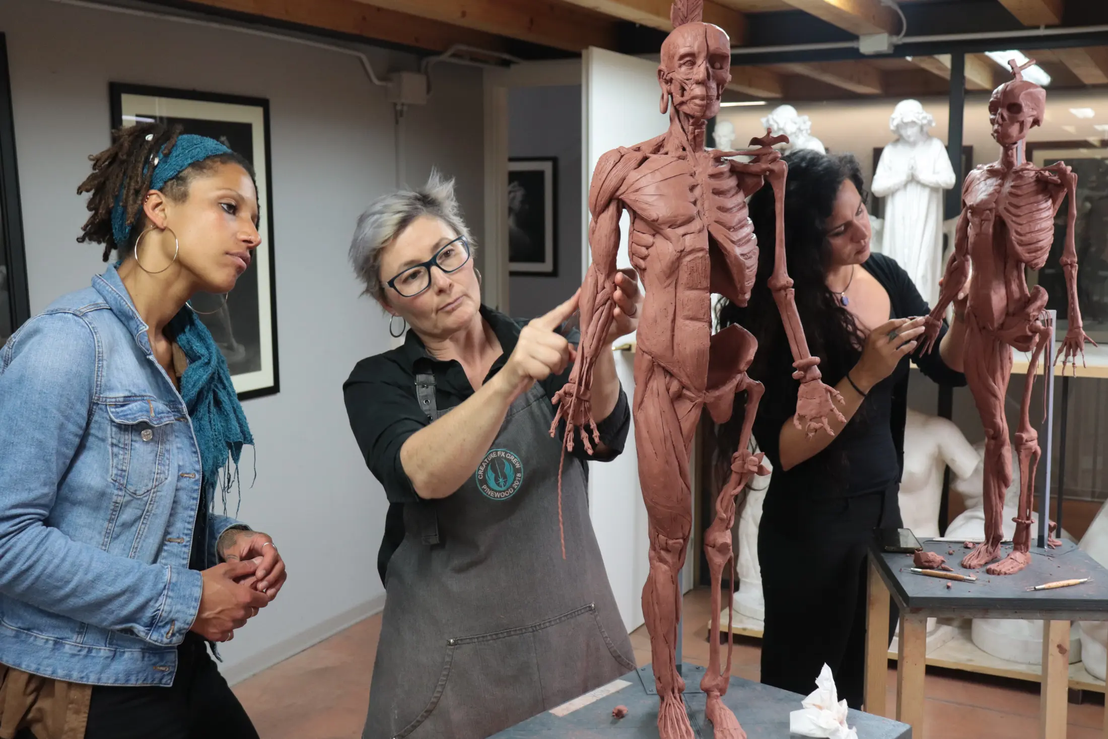 Student getting assistance by sculpture teacher at Florence Academy of Art